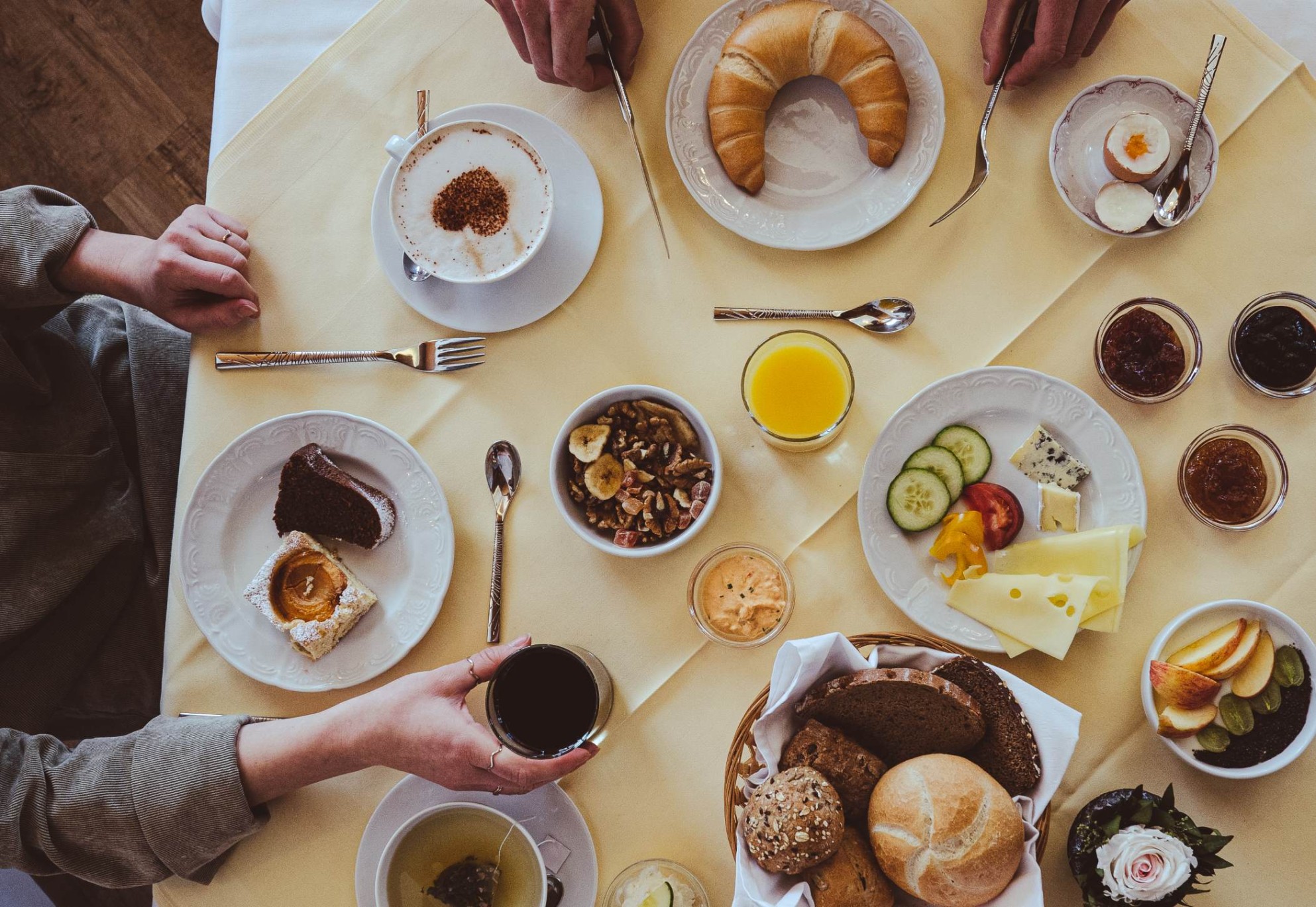 Plentifully set breakfast table with coffee and juice